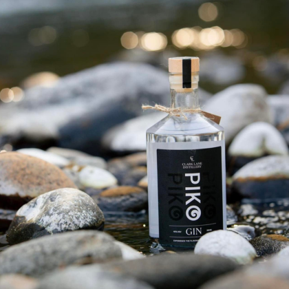 Piko gin bottle on river rocks