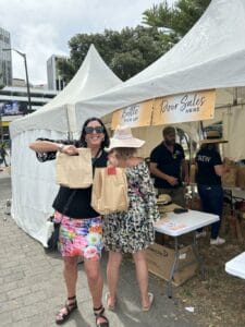 People picking up bags at outdoor booth