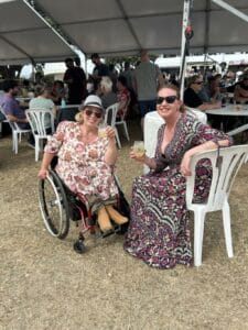 Two women enjoying drinks at an outdoor event