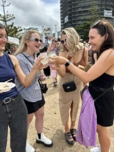 Women toasting drinks at outdoor event