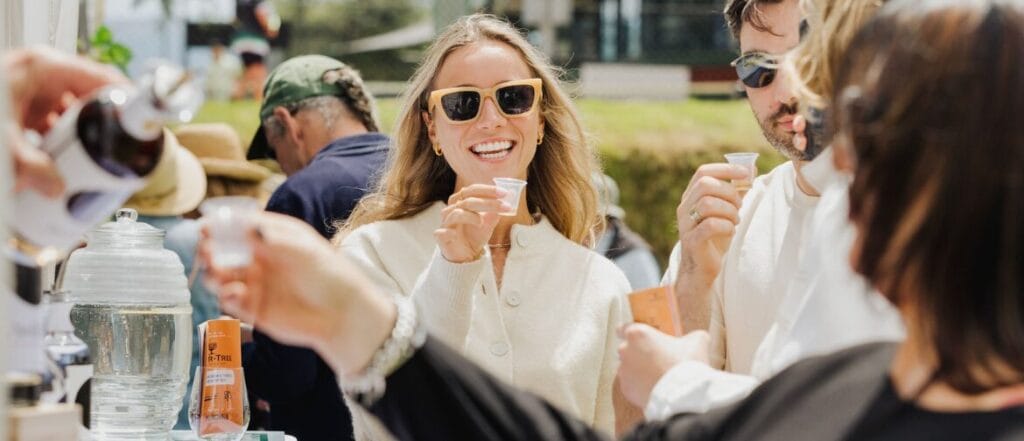 People enjoying outdoor drink tasting event