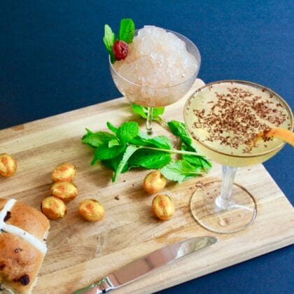Cocktails with buns and snacks on a board.