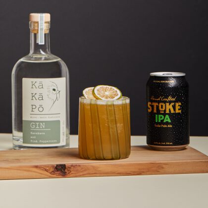 Gin, IPA, and cocktail on a wooden board.