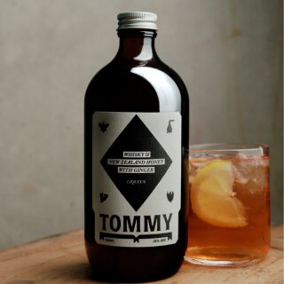 Bottle of Tommy Cocktail with drink beside it